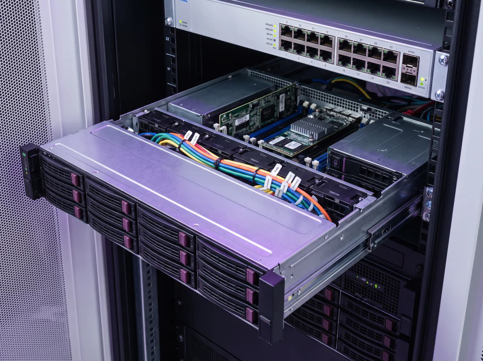 A rack-mount server on its rails, showing drive bays and neatly labelled cabling